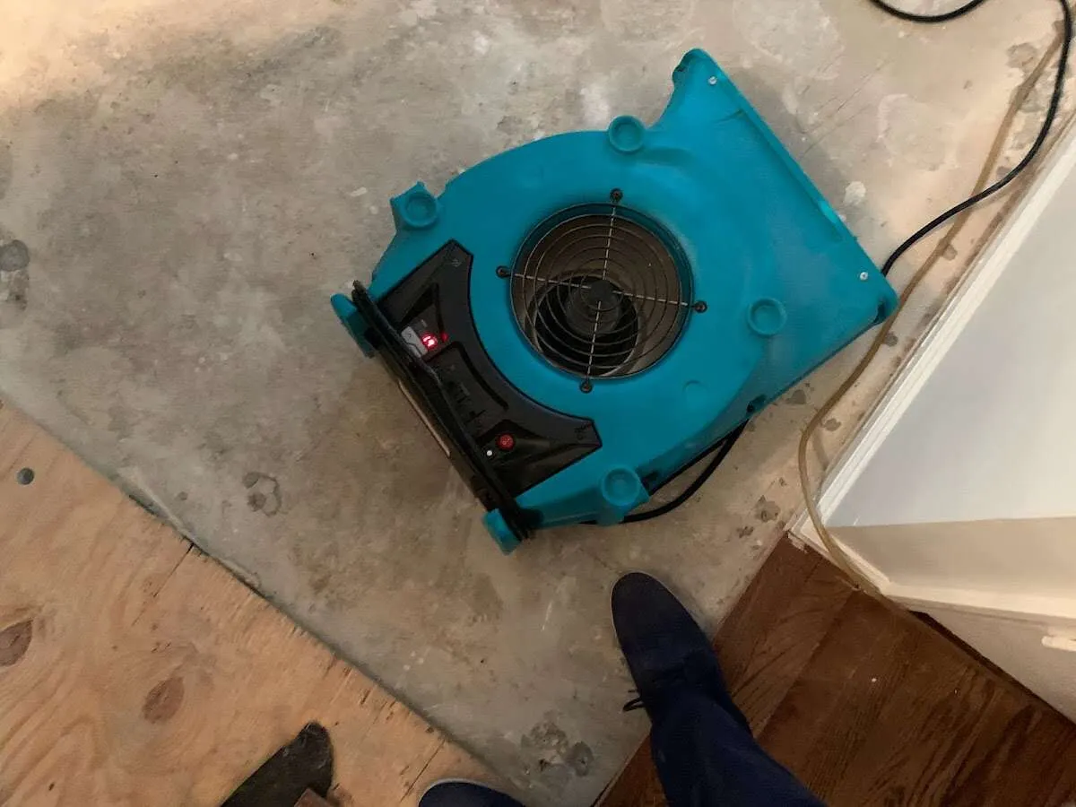 Air mover drying subfloor during Commercial Water Damage Restoration in Hubbard